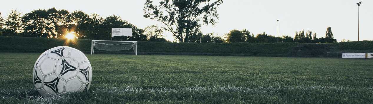 Foto eines Fußballs mit Tor auf einem Fußballplatz